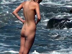 Voyeur must feel amazingly horny while whatching this beautiful gal posing her nude forms while at the beach