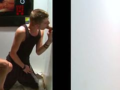 Check out this gay gloryhole scene where this horny twink sucks on this muscular guy's thick cock as it poked out of the wall.