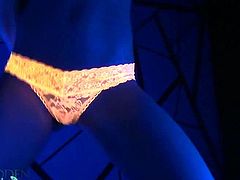 Blonde Madden wears a pair of orange panties and knee-long socks. She puts lotion on her nipples and turns on the black light. She teases with her sexy body.