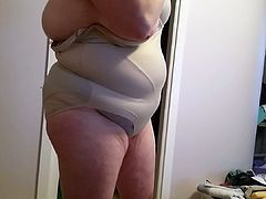 covering her big tits, bbw body with her girdle