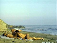 This fun loving couple lays out a towel on the beach then proceed to fuck before he pulls out and cums in her sweet mouth.