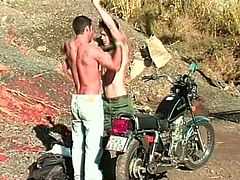 These two guys go for a motorcycle ride. They find a place to park then they strip off their clothes and fuck like crazy.
