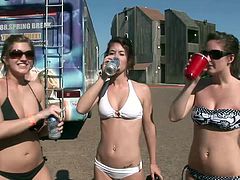 Extra-ordinary babes in colorful bikinis gets drunk after drinking in a crazy out door party while displaying their natural tits