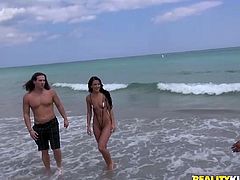 This sexy chick is walking up and down the beach when she is approached by a hunk who is flashing a big wad of cash. He'll give her some money if she shows off her skimpy bathing suit. She strips down to just her tiny bikini and takes a dip in the ocean.