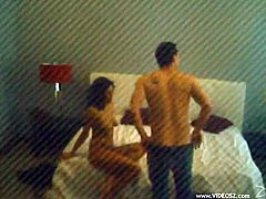 Horny amateur couple are playing dirty games in a hotel room. The woman gives a blowjob to the man and they both know nothing about the security cam.