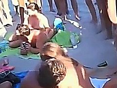 Voyeur captures a crazy girl having a groupsex party with 3 guys on a nudist beach. In the meantime tons of of guys are watching the action, hoping to get a turn too on this super slut.