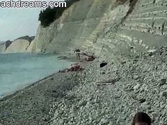 Nude Beach Dreams brings you a hell of a free porn video where you can see how a horny couple decide to fuck at the beach while other hot naked women watch.
