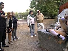 Steve Holmes tied and strapped up his brunette bitch with nice wet pussy, took her to a park, and started fucking her there. Watching such a hot bitch in the action, people gathered around taking photos and stuff. A guy even put his cock and got a blowjob, while Steve was still ramming her hard.
