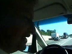 Couple plays in the car while driving
