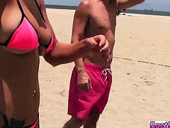 Girls playing with the guys on the beach gets wet and wild