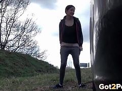 Shiny leggings chick gets behind a car to pee