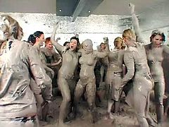 Busty babes in bikinis coated in mud after wrestling