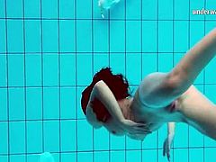 Tight bikini girl does an underwater striptease