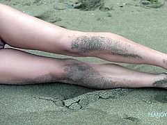 Lorena's nude body is simply perfect. This tall goddess wearing only a pair of pearly earrings has small lovely tits. Click to watch her masturbating on the sandy shores, as the wind plays with her long brown hair.
