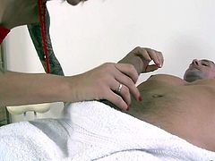Tattooed brunette Nikita Bellucci in red and black stockings teases a man on massage table and then pulls her panties aside. She displays her pink pussy and fingers her asshole.