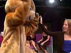 A dude is dancing for some women in his bear costume. The girls rip if off the stripper and then they jump on him to have sex. He has a fun job.