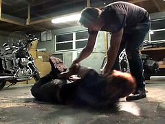 Biker girl hogtied in the garage