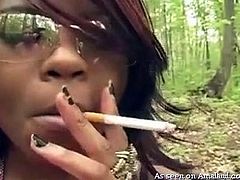 Puff puff! This ebony beauty takes a long drag of her cigarette, as we are out in the woods being naughty. My loving interracial girlfriend blows the smoke all over my dick and sucks me off. What a kinky exhibitionist she is!