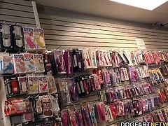Busty blonde Lexi Lowe gets gangbanged and assfucked in adult video store by many black guys.