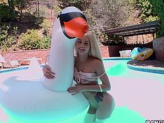 Elsa just has that happy personality. She smiles and is playful outside in the water, and she is just as playful inside the house, although a bit differently. The cameraman sticks out a really long black dildo and watches her, as she starts to suck it.