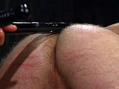 His ass is red and swollen because of the beating that his master is giving him, but he is not going to stop. He is going to continue to beat that ass until it hurts. He will shove his cock deep in there, too.