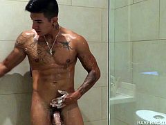 Our featured solo boy of the week is Erick, a muscular and inked young Latino who has invited us to watch as he jerks off in the shower. As the water cascades over his smooth body its impossible to miss that big uncut cock swinging between his legs. With the help of some soap, and a little attention, he quickly gets that meat stiff and ready for action. After a nice long stroke show, the muscles flex and cum starts pumping. Damn this boy is hot