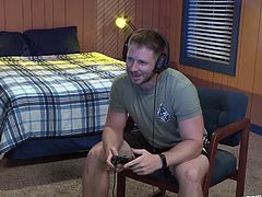 This twink is relaxing in his dorm and playing a naughty video game that involves hot gay sex. He controls the hunks in the game and they suck each other's rock hard cocks. His goal in the game to to make it through a hardcore assfucking.