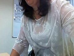 Webcam secretary flashes her heavy hangers in the office
