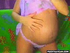 A webcam recording of some lady strutting her stuff on webcam, showing off her beautiful tits and big pregnant belly to her kinky viewers.