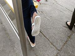 Candid cute girl feet on bus stop