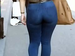 Hot girl in tight jeans walking on the street