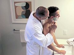 Dads have been teaching their guys how to shave for ages. Very few, however, get hard by doing it. Luckily for this guy, his friend has no trouble giving him a hand and showing him a thing or two in the bathroom. But seeing the young guy in just a towel, he can hardly contain himself, leading him to give him a really important lesson: how to get fucked by his old man!
