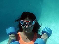 Sexy one piece swimsuit on a girl working out underwater