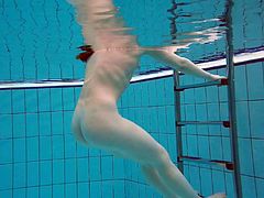 Sweet looking swimmer Katrin Bulbul is striping under the water
