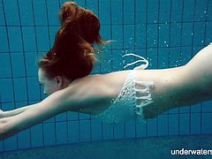Red haired swimmer Diana Zelenkina is stripping under the water