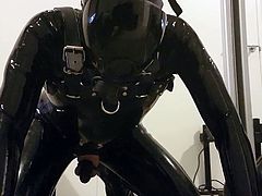 Caged latex gimp testing out a new fucking machine