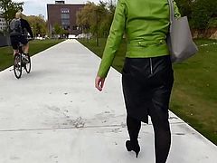 Nice lady in tight leather skirt walking outside