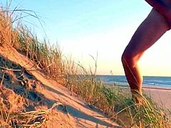 Boy wanks in The dunes of the beach