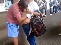 He sucks his girlfriend's tits while waiting for the bus