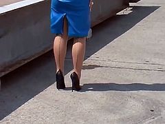 Walking in blue Leather skirt and high heels