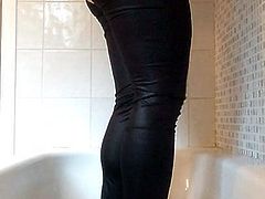 Sissy girl wets herself in shiny swimsuit and wetlook leggin