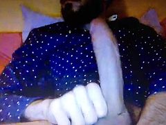 Bearded dude jerking his huge hung cock