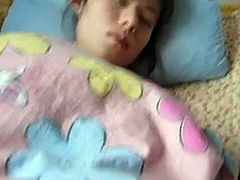 Some perv films on as he explores the bushy pussy of a sleeping girl and then jerks off.