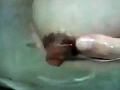 Asian girl massages her swolen tits and a stream of mothermilk starts to flow