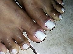 Closeup on Morenafeet's fingers with French nail polish