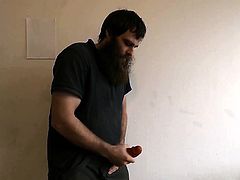 Man strokes his large cock dildo